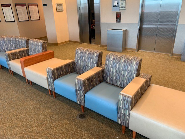 Coordinated upholstered chairs and benches in a facility lobby