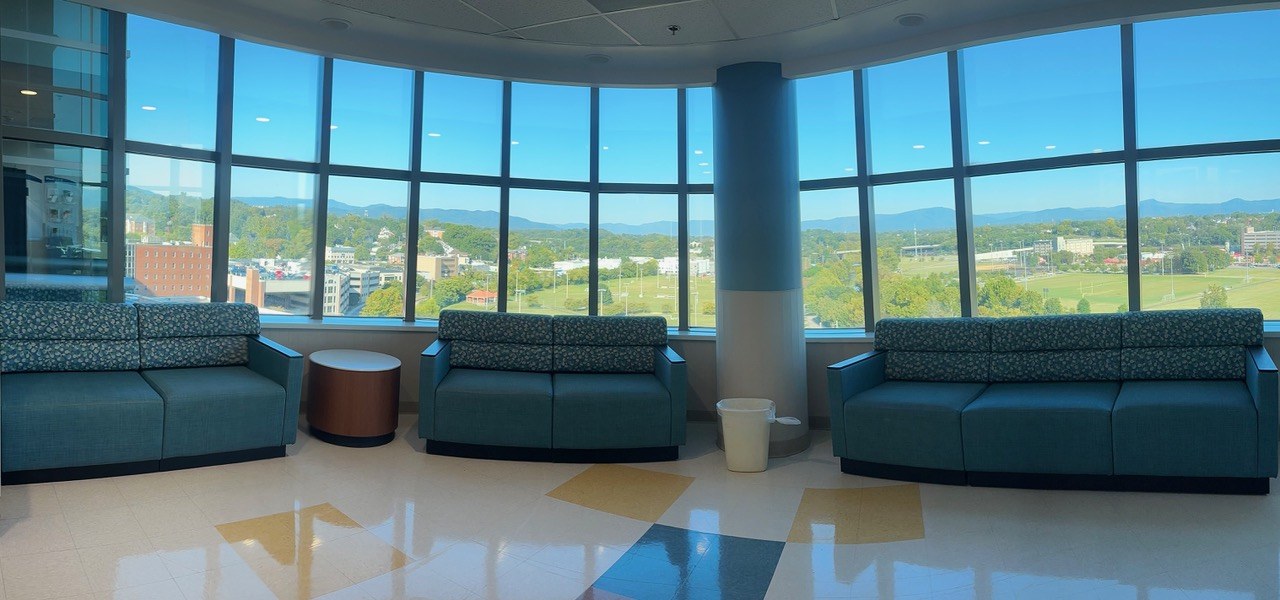Upholstered lobby seating along a panoramic window wall